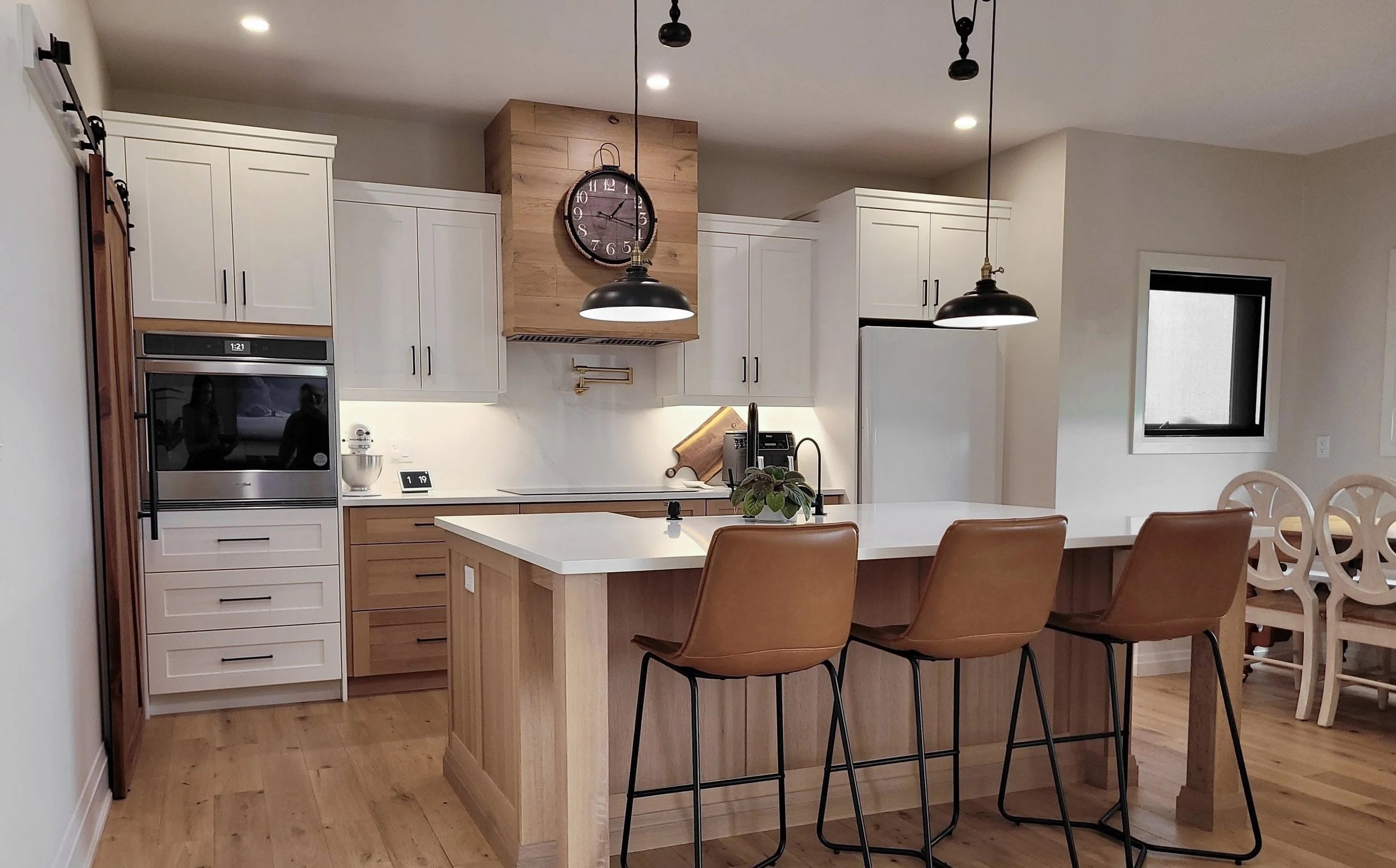 A custom Vanderschaaf kitchen with white and natural wood cabinetry