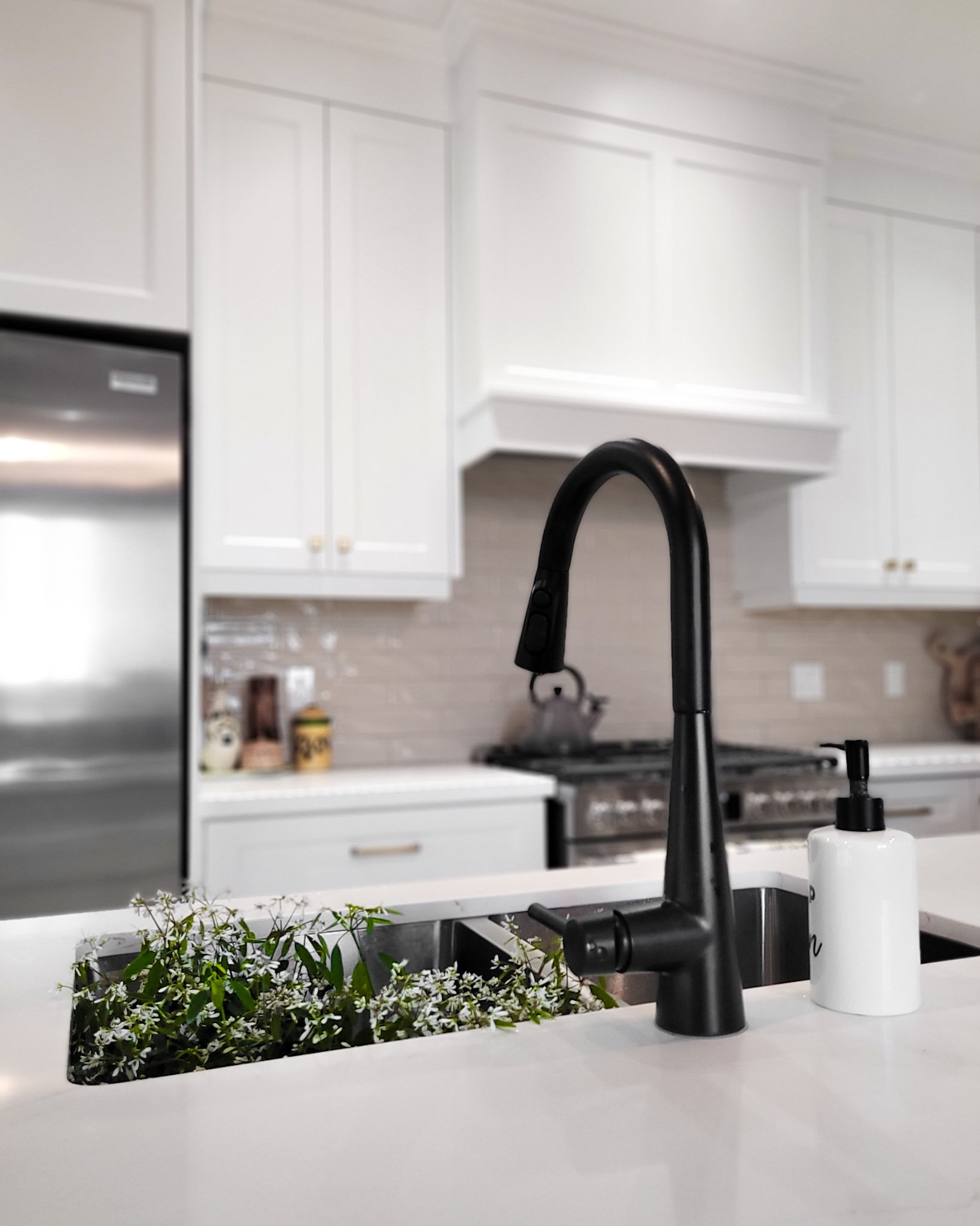 A kitchen sink and faucet set against custom cabinetry